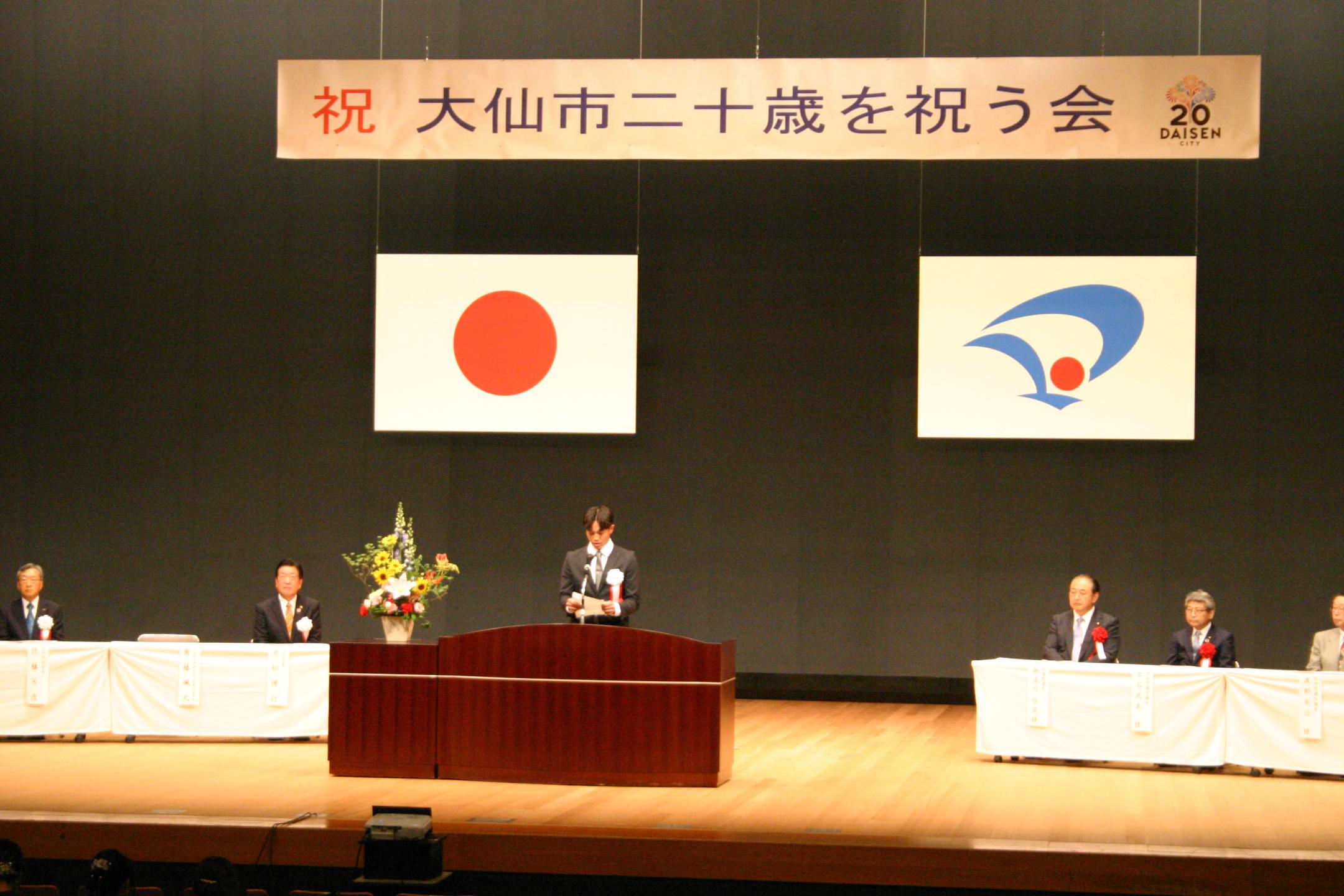 ステージ上で実行委員長が挨拶している