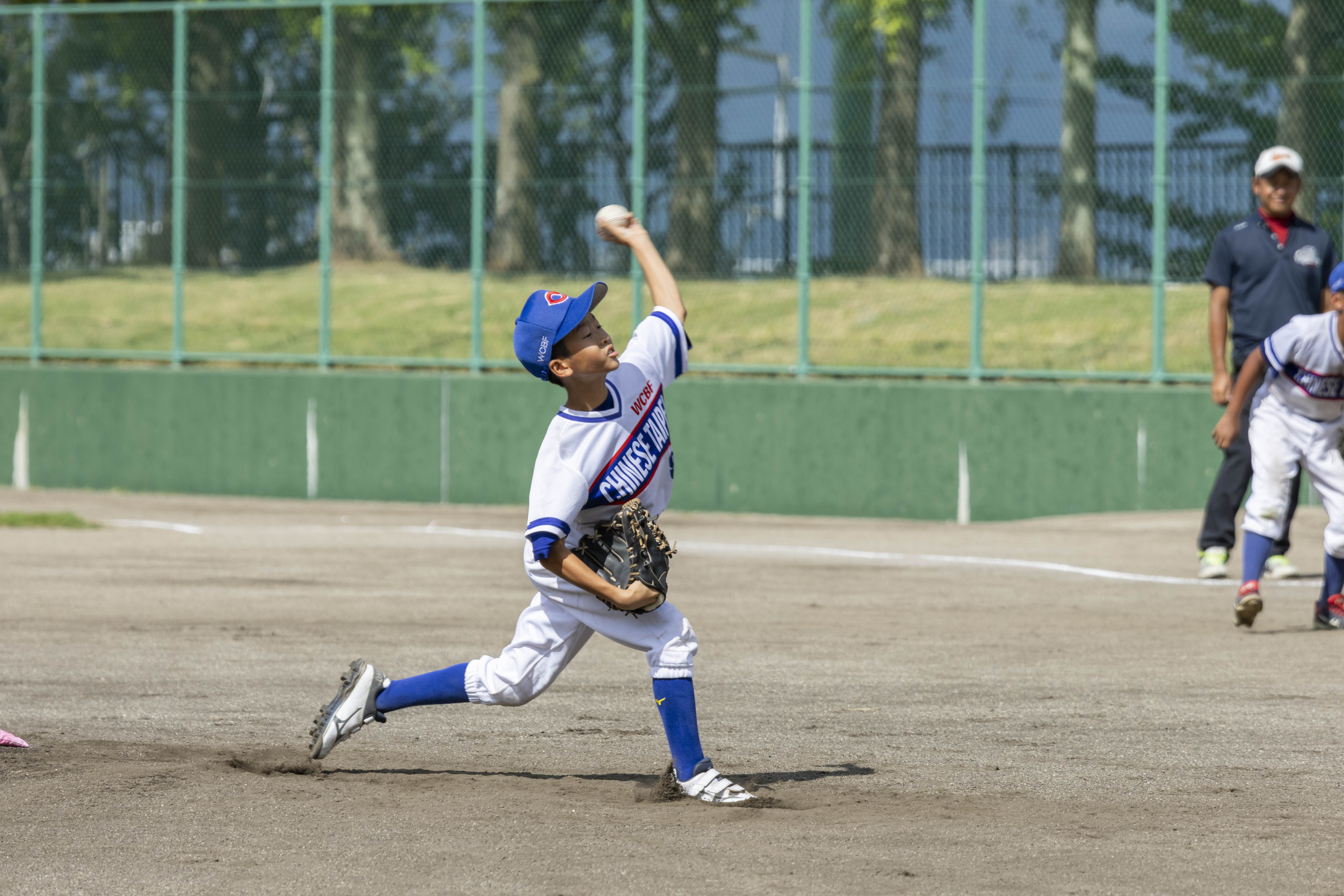 サウスポーの少年ピッチャーがマウンドから投球する様子