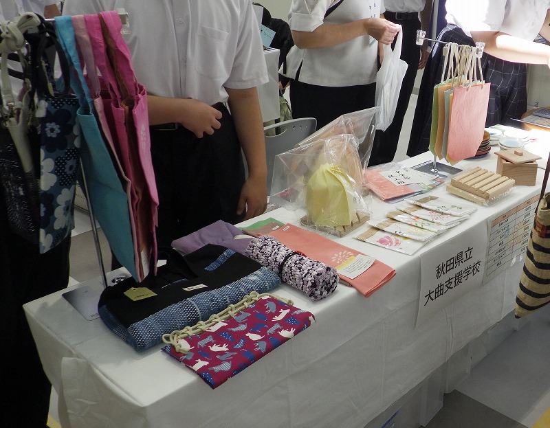大曲支援学校の販売ブース、小皿、箸置き、木工製品、陶芸製品などが並んでいる