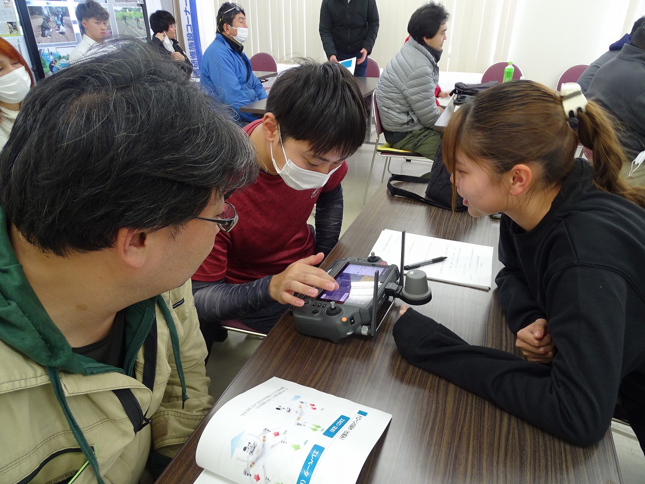 座学によるドローン講習会でリモコンを手にする研修生